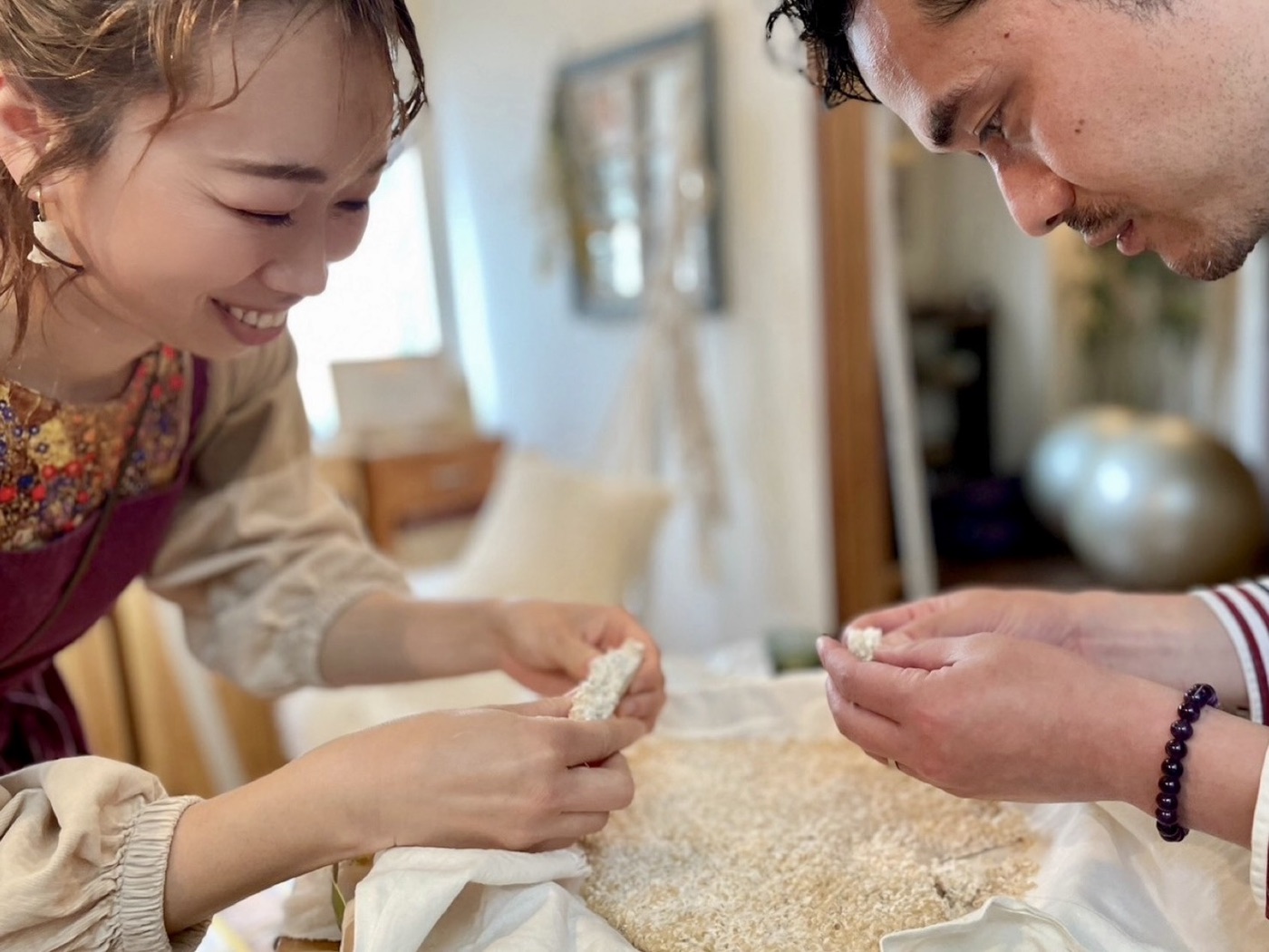 出来上がった米麹を手に取り、笑顔で確かめ合う髙須賀夫妻